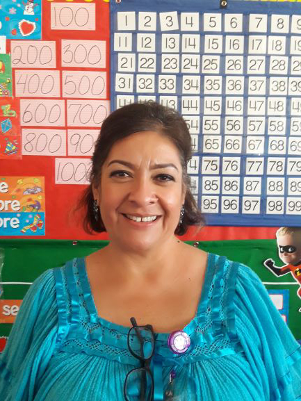 Second-grade teacher Sonia Castellanos smiling in her classroom