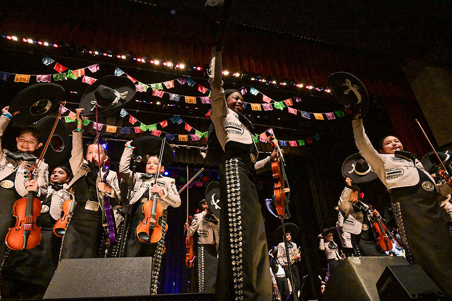 Las Aguilitas stands on the stage for applause after their performance