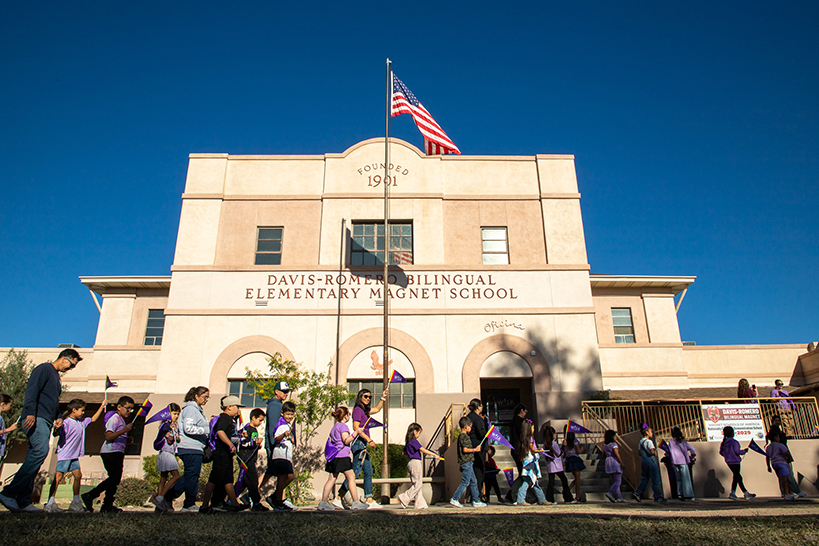 Students walk in front of their school