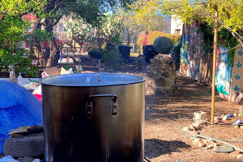A pot of soup simmers in the school garden