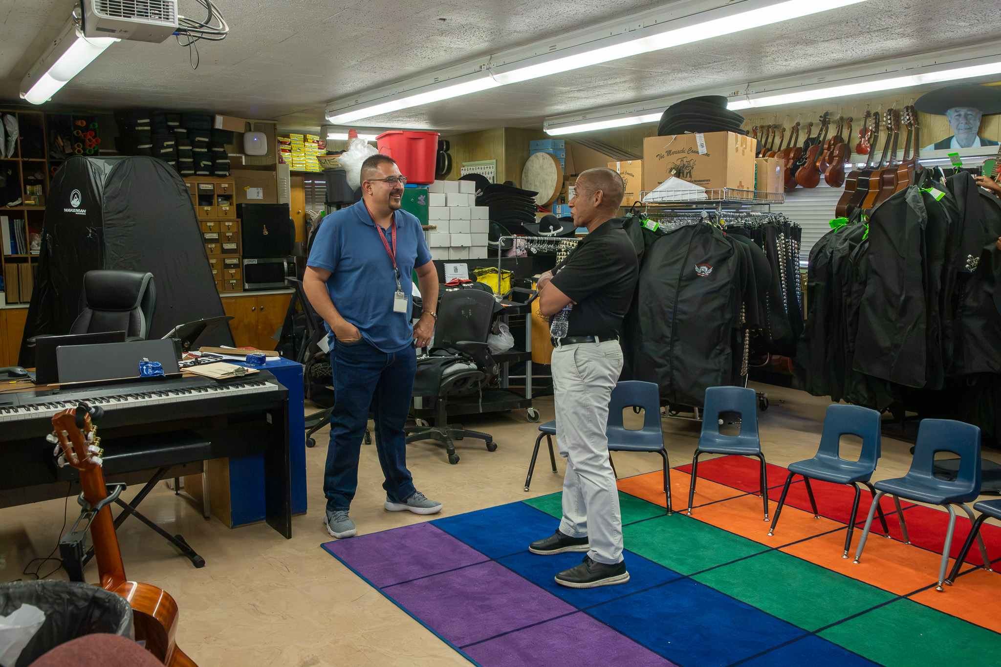 Dr. Trujillo talks with the mariachi teacher in his classroom