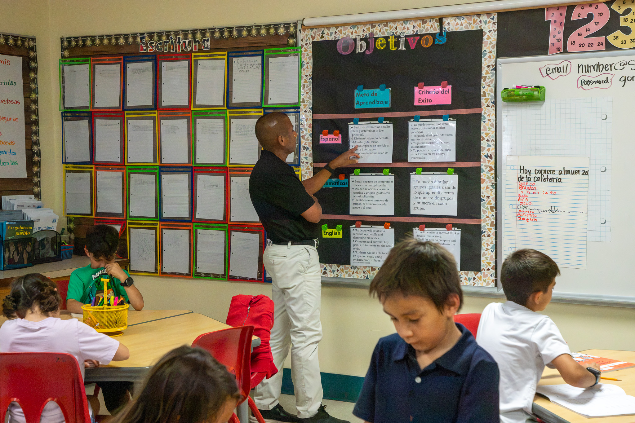 Dr Trujillo looks at a board on the classroom wall