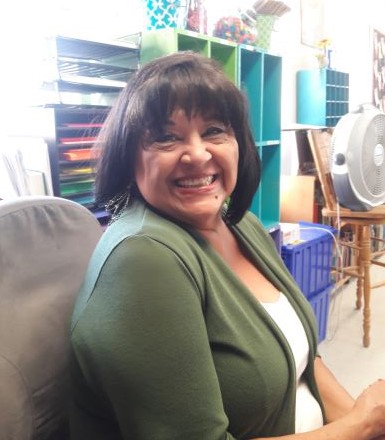 TA Himelda Rodriguez smiling in a classroom