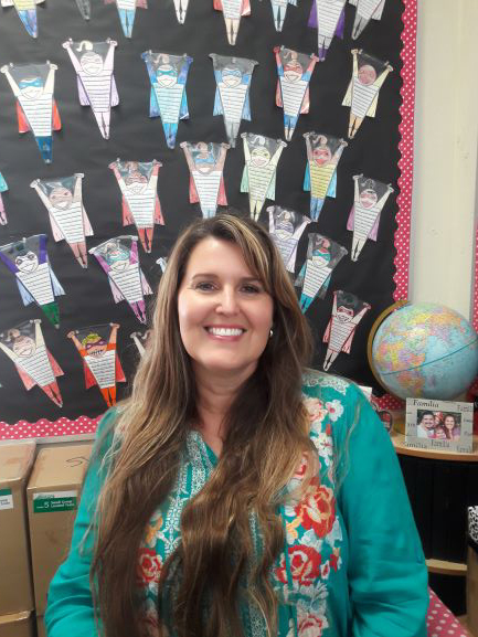 Fourth grade teacher Tessa Valencia smiling in her classroom