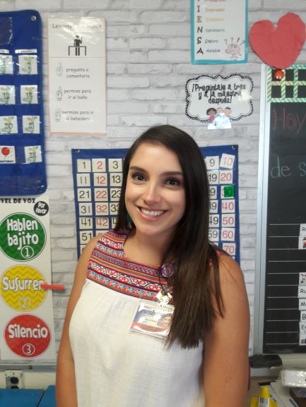 Third grade teacher Mayte Villegas smiles in a classroom